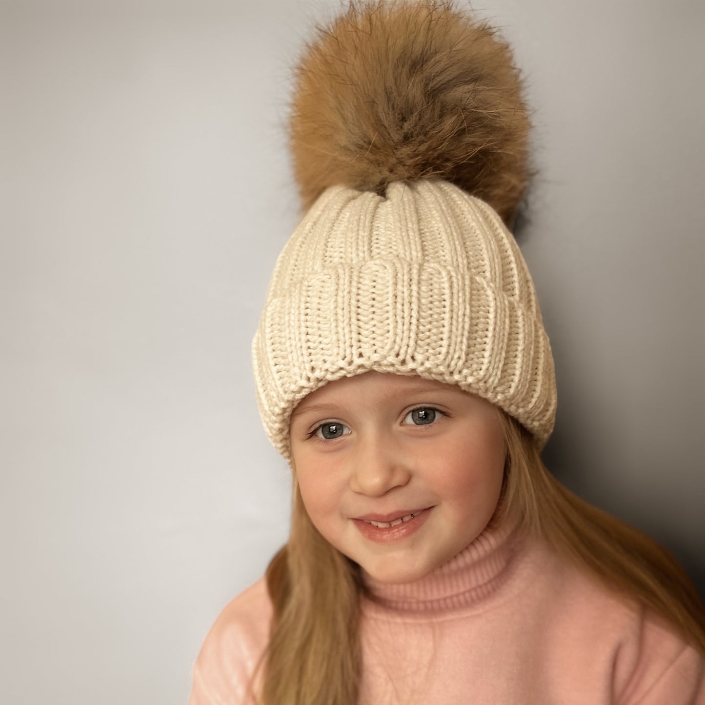 Knitted hat with tuft