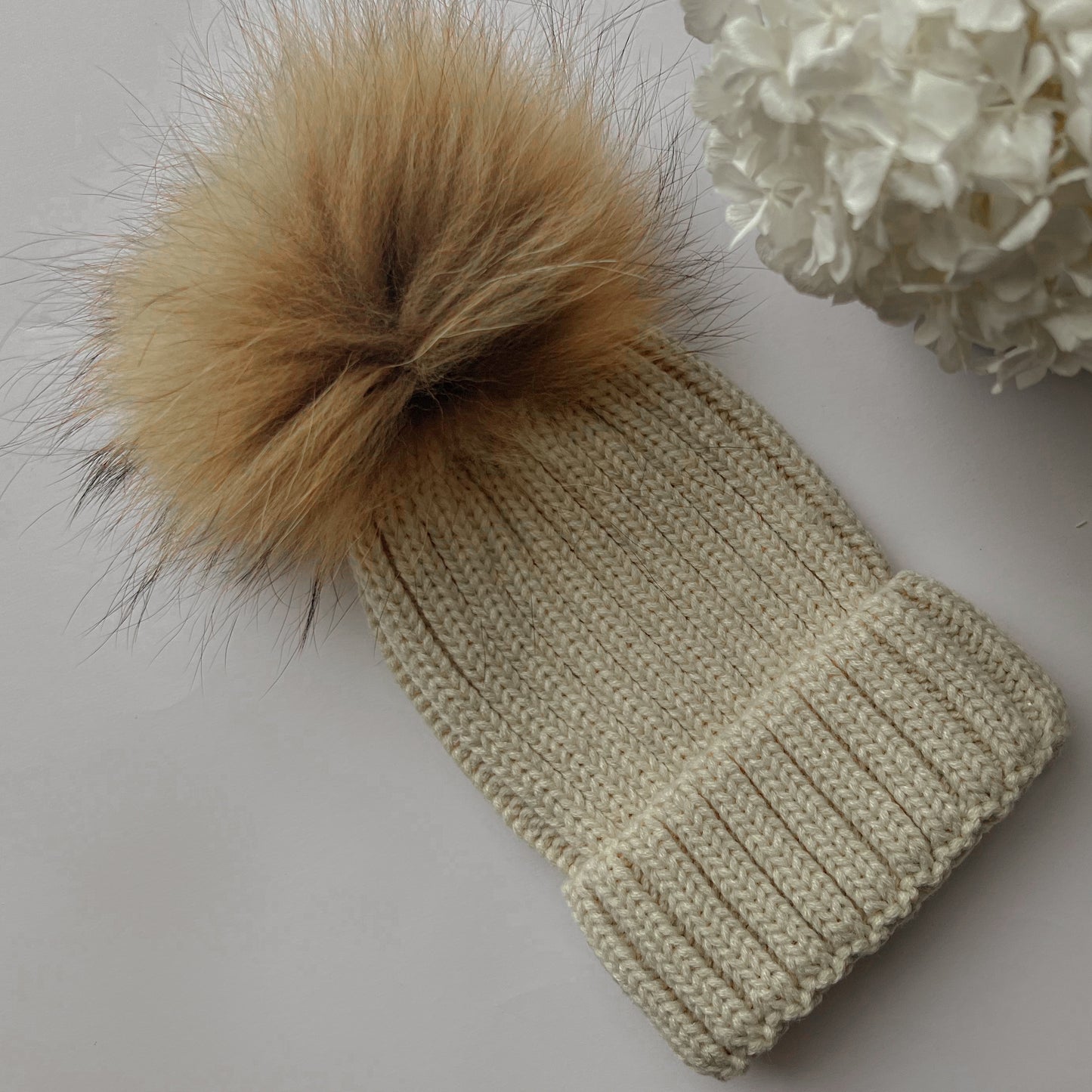 Knitted hat with tuft