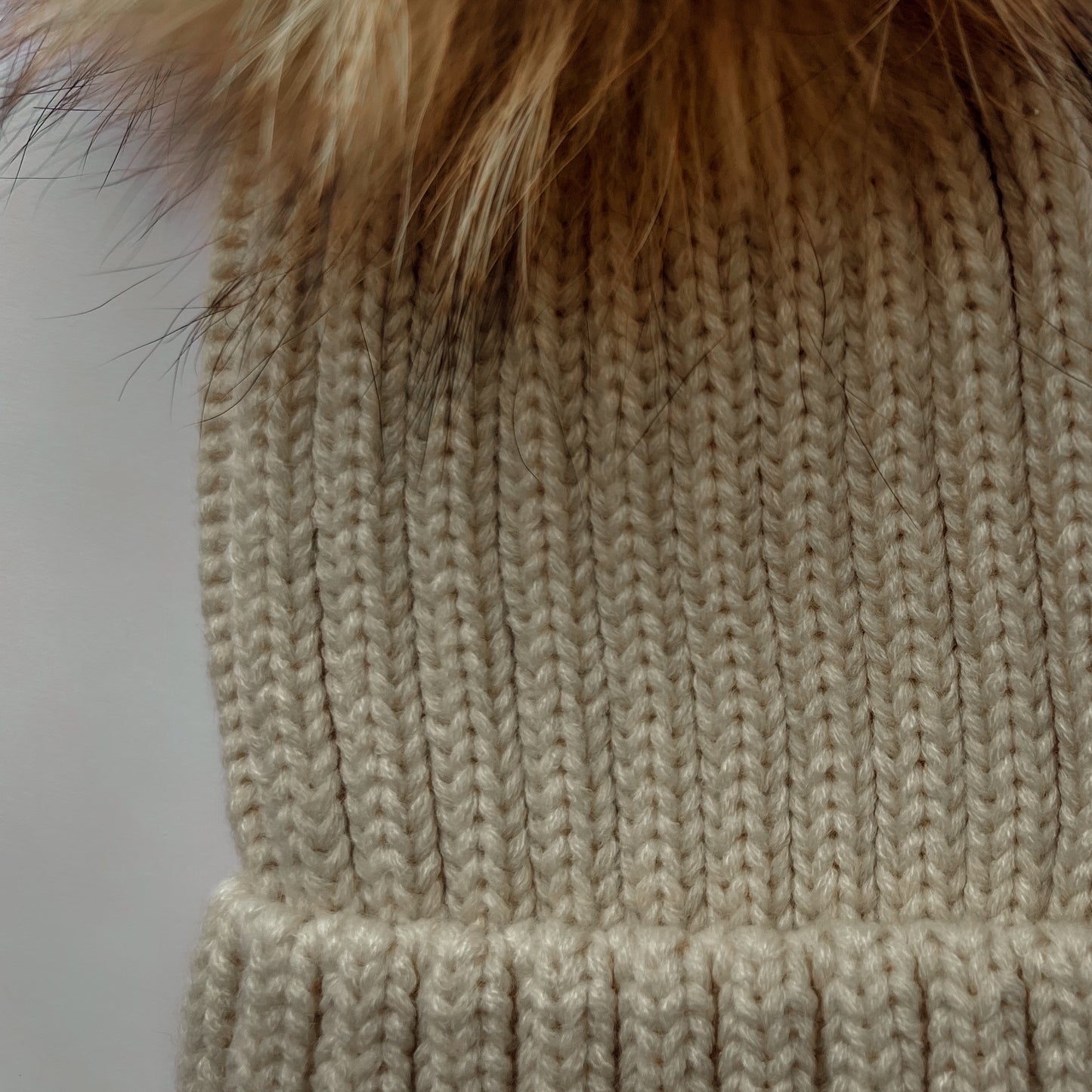 Knitted hat with tuft